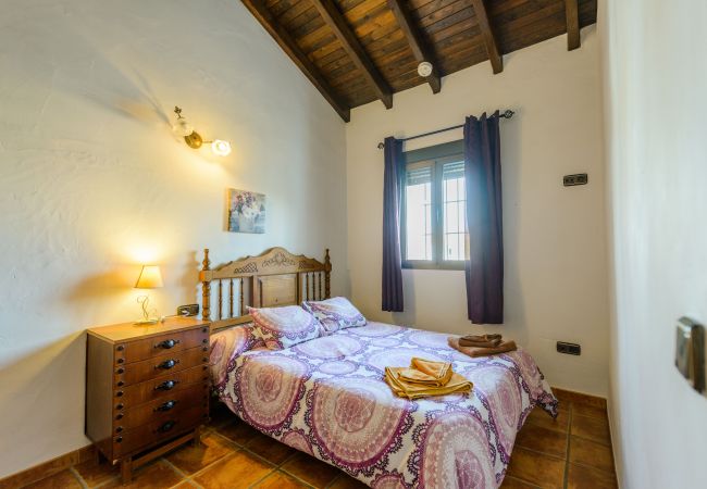 Dormitorio de esta casa con chimenea en Alhaurín el Grande