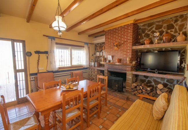 Living room with fireplace in this villa in Ardales