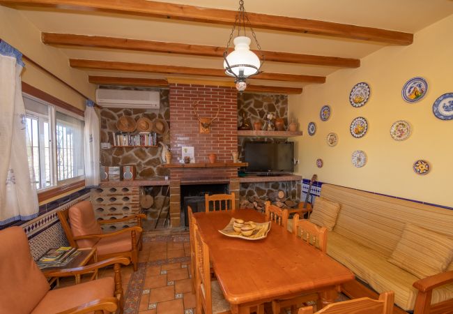 Living room with fireplace in this villa in Ardales