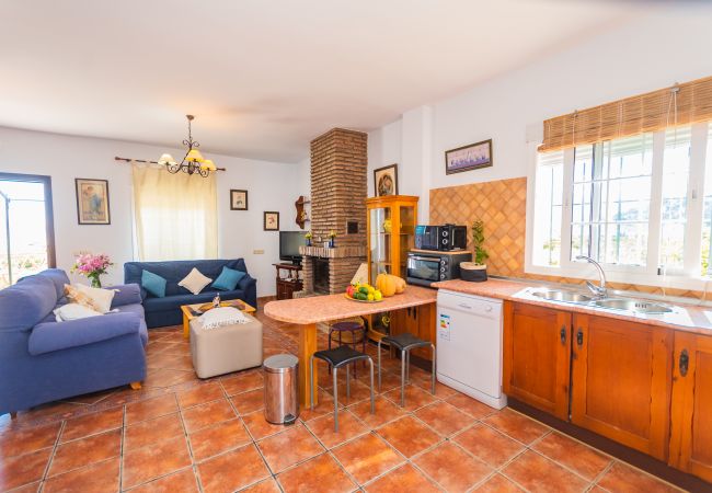 Kitchen of this house with fireplace in Coín